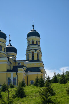 Orthodox Cathedral with domes in monastery against background of green landscape and cloudy sky. Hincu Monastery in Moldova was founded in 1678. Concept religion, christianity, orthodoxy.