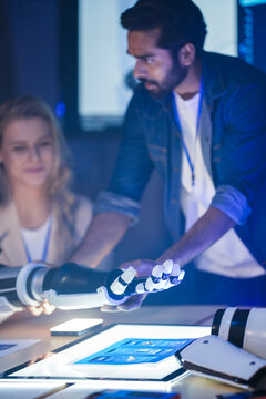 A startup founder presents a breakthrough in future medical technology. He holds an innovative AI robotic prosthetic, a solution for digital transformation in healthcare.