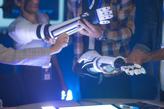A startup team develops future medical technology. The diverse engineers test a new AI robotic prosthetic, an innovative solution for healthcare and digital transformation.