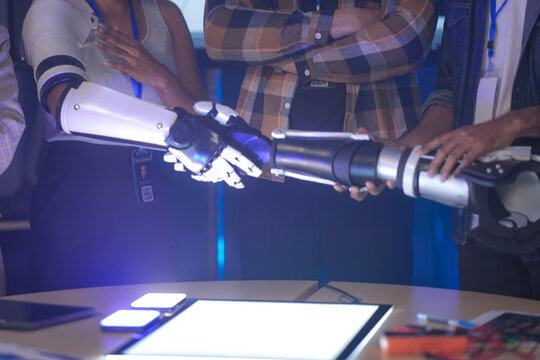 A startup team develops future medical technology. The diverse engineers test a new AI robotic prosthetic, an innovative solution for healthcare and digital transformation.