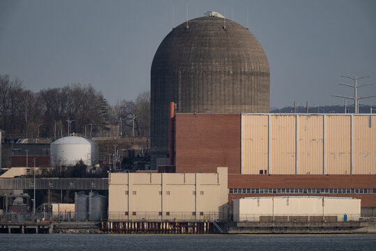Aerial view of the Indian Point Energy Center IPEC showing the massive concrete containment dome and industrial facility buildings along the waterfront in Buchanan, New York, United States.