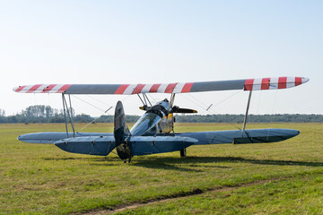 Soviet-made World War II green biplane on a grassy airfield © ZenitX