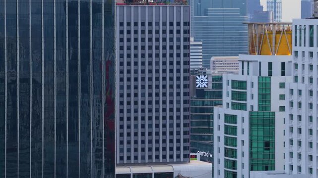 Majestic aerial view of Bangkok's cityscape, revealing MahaNakhon tower behind modern buildings and Berkeley Hotel Pratunam golden dome