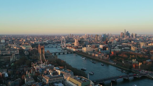 Elevated cityscape of London with River Thames, Palace of Westminster, Big Ben, and London Eye during a golden hour sunset