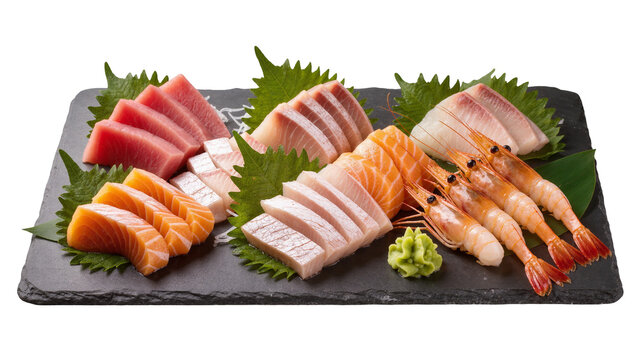 Assorted raw fish sashimi and shrimp on dark slate plate with garnish