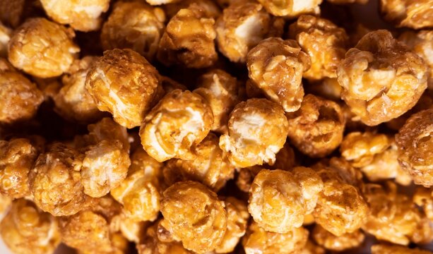 Close up of caramel popcorn texture with glossy coating. Food background