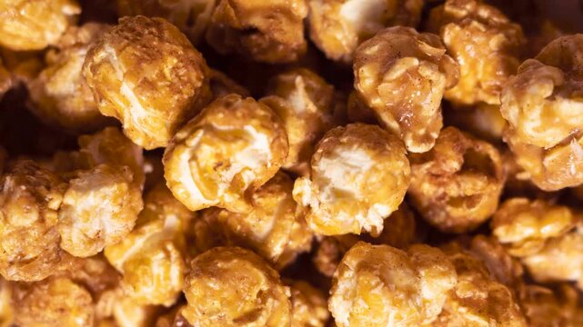 Close up of caramel popcorn texture with glossy coating. Food background