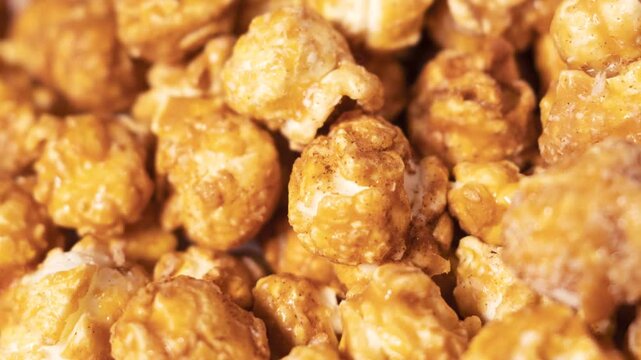 Close up of caramel popcorn texture with glossy coating. Food background