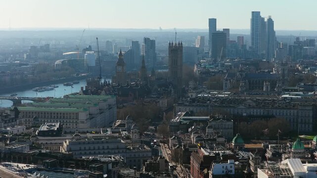 Aerial panorama of London showcasing River Thames, iconic Palace of Westminster with Big Ben, and sprawling cityscape of historic and modern architecture