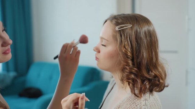 Woman Getting Makeup In Cozy Room, Caucasian Woman Receives Makeup From Friend In Relaxed Environment, Young Woman With Natural Hair Being Assisted By Friend In Tranquil Living Space