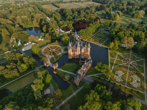 Aerial view of De Haar Castle featuring medieval architecture and pointed towers surrounded by a water moat and manicured formal gardens with geometric patterns Utrecht, Utrecht, Netherlands.