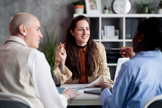Diverse businesswomen collaborating and discussing ideas in office meeting