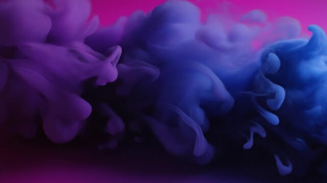 Vibrant purple and blue ink clouds diffuse through water creating mesmerizing abstract motion patterns in this creative digital video animation