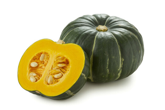 Fresh whole and sliced green kabocha squash revealing bright orange interior