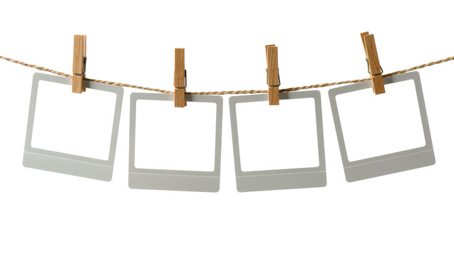 Four empty instant photo frames hanging on a clothesline with wooden pegs, isolated on transparent background