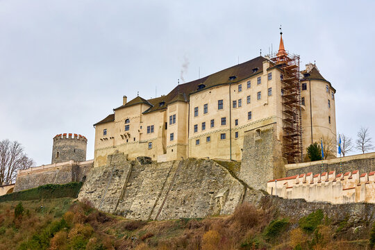 Medieval stone castle with tower and scaffolding on overcast day. March 15, 2026, Cesky Sternberk, Czech Republic