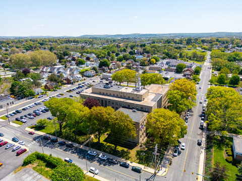 Aerial view of a modern municipal government building and courthouse complex in a small city.