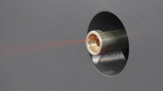 Moscow. Russia, 11.03.2026 Industrial nozzle spraying fine liquid stream during manufacturing process. Precision spray equipment for coating application and chemical processing in factory facility.