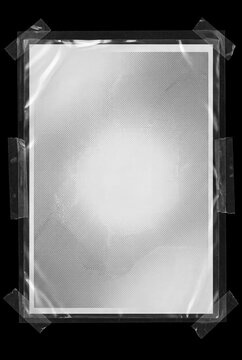 Transparent plastic film sheet taped on black background with halftone texture overlay