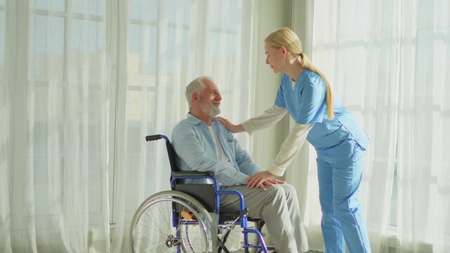 Help support retirement healthcare. Nurse helping old man in wheelchair. Patient and woman in nursing home for medical caregiver. Nurse taking care of paralyzed man in chair for people with disability