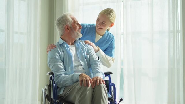 Help support retirement healthcare. Nurse helping old man in wheelchair. Patient and woman in nursing home for medical caregiver. Nurse taking care of paralyzed man in chair for people with disability