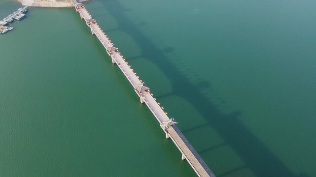 Scenic mountain lake bridge with red flags