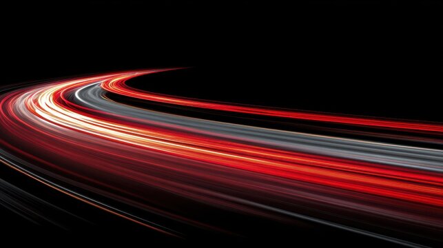Long exposure light trails from vehicle headlights and taillights moving along a curved highway road at night captured with a slow shutter speed technique on black background