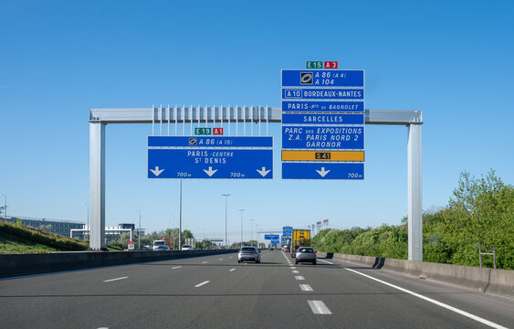 View of a French and European autoroute with overhead directional signs pointing to major cities like Paris, Bordeaux, Lille, Calais, showing lanes, traffic and motorway infrastructure, road signes