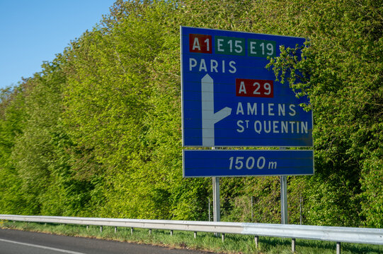 View of a French and European autoroute with overhead directional signs pointing to major cities like Paris, Bordeaux, Lille, Calais, showing lanes, traffic and motorway infrastructure, road signes