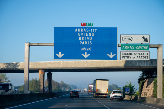 View of a French and European autoroute with overhead directional signs pointing to major cities like Paris, Bordeaux, Lille, Calais, showing lanes, traffic and motorway infrastructure, road signes