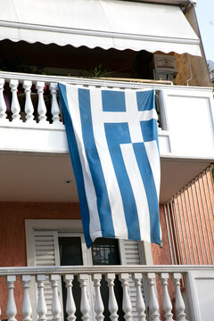 Greek flag hanging from balcony