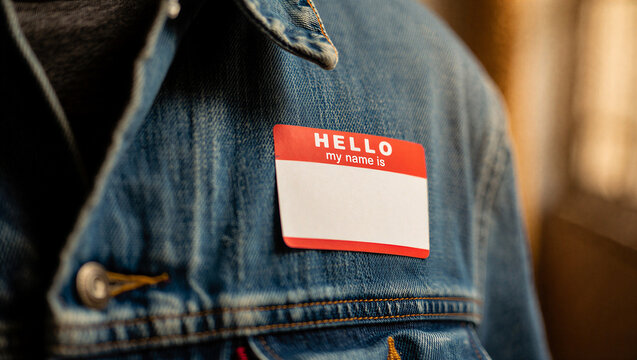 Closeup of a blank hello my name is sticker on a denim jacket