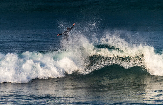 surfer bailout the back of a wave