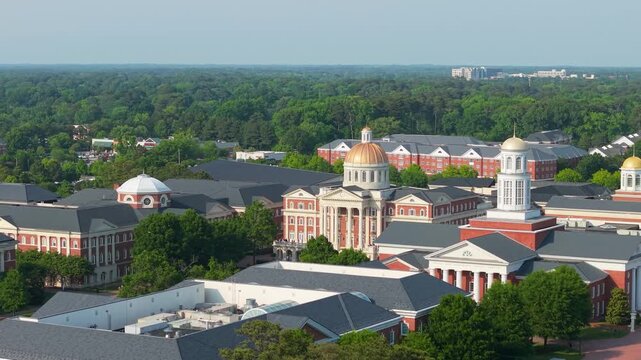 Christopher Newport University campus, a sweeping aerial drone view showcasing the grand neoclassical brick architecture, iconic golden domes, and manicured green lawns of the CNU campus in Newport Ne