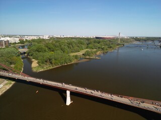 Warszawa - Polska - panorama Warszawy wykonana dronem. Rzeka Wisła, kościół, wieżowce, bloki, ulice w słoneczny dzień © Konrad