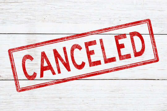 Cancelled red distressed stamp on weathered wood