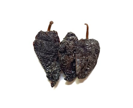 Three dried chile pasa guatemalan pasilla chili peppers isolated on white background