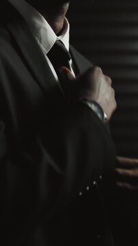 Hands, assassin and suit with getting ready for secret mission, espionage and danger at office. Person, government agent or tie for fashion on undercover assignment, career or hitman with clothes