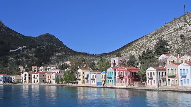 Colorful houses line the waterfront of Kastellorizo harbor in Greece