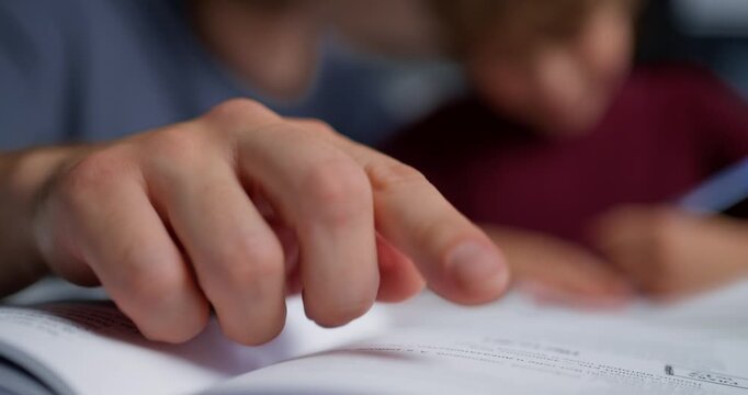 Boy Practices With Focused Concentration. Detailed Scene Of Student Carefully Learning On Textured Paper