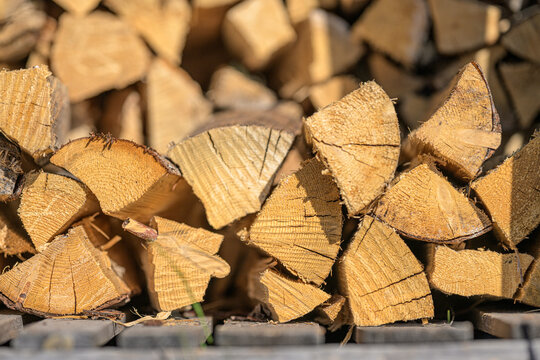 Close up of chopped firewood logs showing natural wood grain texture and patterns.