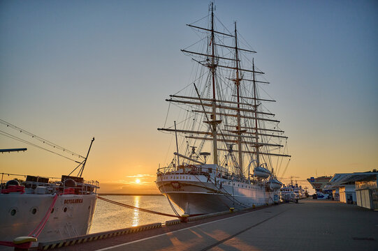 Museum ships Dar Pomorza and ORP Blyskawica moored at the wharf during sunset, Gdynia, Pomorskie, Poland, Europe.