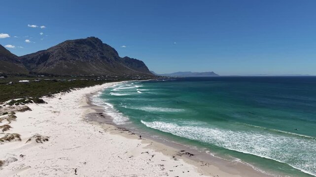 White sandy beach at Betty&rsquo;s Bay, South Africa, captured by drone from above, vivid summer colors, empty coastline, wide horizon, fresh air, calm atmosphere and sense of freedom.