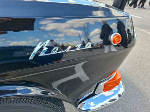 VORONEZH, Russia - April 25, 2026.Detail of polished black Soviet era GAZ Volga showing classic cursive model nameplate and chrome body accents in a city street setting