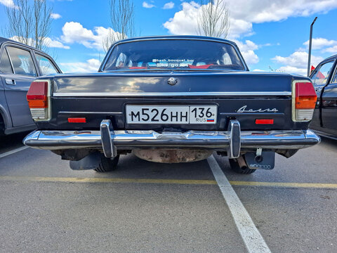 VORONEZH, Russia - April 25, 2026.Classic black Soviet GAZ Volga sedan viewed from rear at retro car show with chrome bumper and Russian license plate