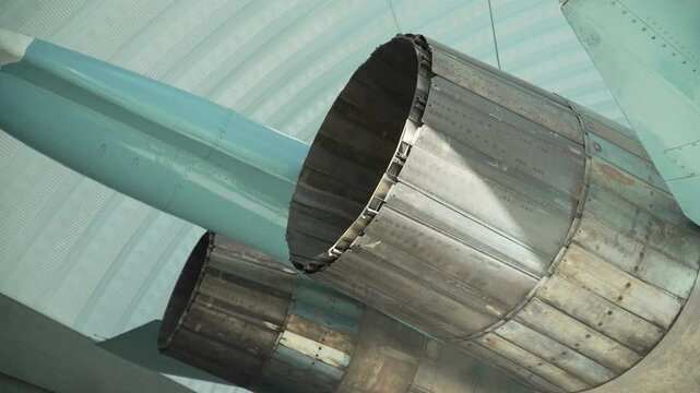 Rear controlled nozzles of fighter jet made of composite plates in hangar closeup. Rear part of supersonic fighter jet.
