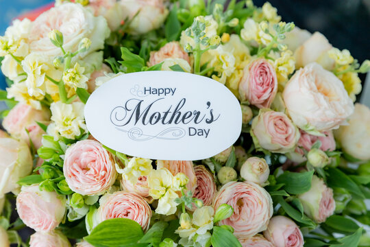 Happy Mother's Day Card and Bouquet. Flowers background. spring holiday concept.heart and blossoms.beautiful bright bouquet with a gift card with the text inscription.sweet wish concept