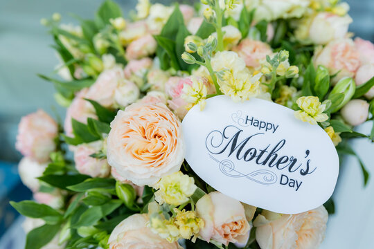 Happy Mother's Day Card and Bouquet. Flowers background. spring holiday concept.heart and blossoms.beautiful bright bouquet with a gift card with the text inscription.sweet wish concept