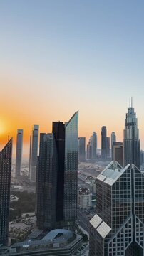 Vertical panoramic view of Downtown Dubai skyline at sunrise, UAE