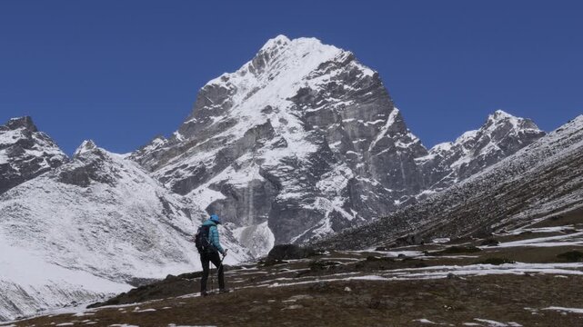Hiker trekking toward Cholatse peak in Himalayas, Khumbu region, Nepal